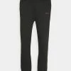 Mennace ESSENTIAL UNISEX - Tracksuit Bottoms - Black -Mennace Shop Online 2c9d29c160b14641ba9a585d72526390
